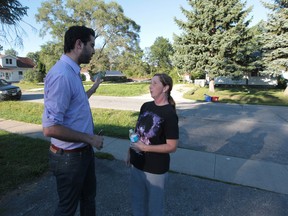 Windsor Coun. Al Magneigh left, and Longfellow resident Heather Akins talk about another neighbours road that was built on City of Windsor property.  (The Windsor Star)