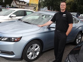 Jeff Reaume, general sales manager at Reaume Chevrolet Buick GMC in LaSalle, stands next to a 2014 Chevrolet Impala. "We're seeing more boomers buying because they're the ones with good jobs, paid-off houses and less debt." (DAX MELMER / The Windsor Star)