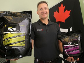 Darcy Haggith, president of Infinit Nutrition poses Friday, Sept. 20, 2013, with samples of his sports performance blends. (DAN JANISSE/The Windsor Star)