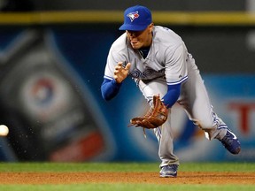 Toronto shortstop Ryan Goins fields a ground ball hit by the Chicago's Paul Konerko Monday, Sept. 23, 2013, in Chicago. Konerko was out at first base. (AP Photo/Andrew A. Nelles)