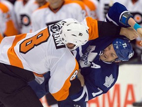 Philadelphia's Nicklas Grossmann, left, and Toronto's David Clarkson fight during NHL pre-season action in Toronto on Monday September 16, 2013. The Flyers won 3-2 in a shootout. (THE CANADIAN PRESS/Frank Gunn)