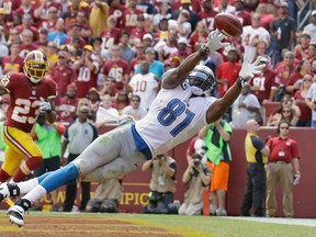 Detroit Lions tight end Brandon Pettigrew, right, can't quite reach a Matthew Stafford pass in the end zone as Washington Redskins cornerback DeAngelo Hall watches in the background in Landover, Md., Sunday, Sept. 22, 2013. The Lions won 27-20. (AP Photo/Alex Brandon)