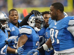 Reggie Bush, centre, of the Detroit Lions celebrates with his teammates after running 77 yards for a touchdown against the Minnesota Vikings at Ford Field on September 8, 2013 in Detroit. (Leon Halip/Getty Images)
