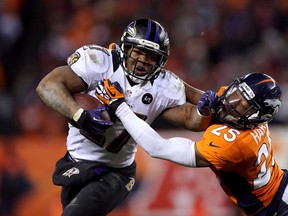 Baltimore's Ray Rice, left, stiff arms Denver's Chris Harris during the AFC Divisional Playoff Game at Mile High on January 12, 2013 in Denver. The Ravens and Broncos open the NFL season Thursday. (Jeff Gross/Getty Images)