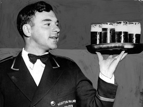 Bill Miller contemplates a full tray of beers as he toted them into the tap room of the Norton Palmer where a crowd of thirsty men were awaiting him for him in this undated file photo. (FILES/The Windsor Star)