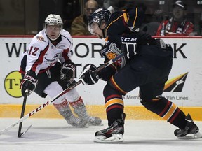 Windsor's Ben Johnson, left, and Barrie's Aaron Ekblad battle last seasion at the WFCU Centre. Ekblad, a Belle River native, and the Colts are ranked No. 1 in the OHL Eastern Conference. (DAN JANISSE/The Windsor Star)