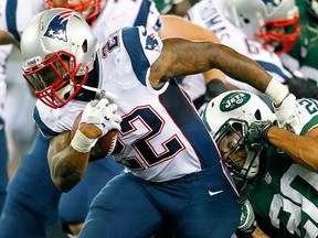 New England running back Stevan Ridley, left, fights off the tackle of New York Jet Kyle Wilson last season in East Rutherford, N.J. The Jets and Patriots will open Week 2 of the NFL season Thursday (8 p.m., RSO) in New England. (Rich Schultz /Getty Images)