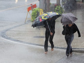 Files: Showers send people scrambling in downtown Windsor on July 18, 2013.  (TYLER BROWNBRIDGE/The Windsor Star)