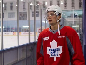 Toronto's Mason Raymond makes his way on to the ice for a practice session at their NHL training camp in Toronto. The Leafs have signed left-winger Raymond to a one-year deal. THE CANADIAN PRESS/Chris Young)