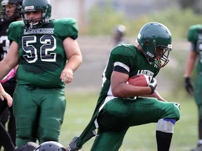Lajeunesse running back Matthieu Pickens , right, pulls away from a shirt tackle by Riverside's Alex Jones in high school football action from Windsor Stadium September 19, 2013. Pickens scored a touchdown on the play. (NICK BRANCACCIO/The Windsor Star)