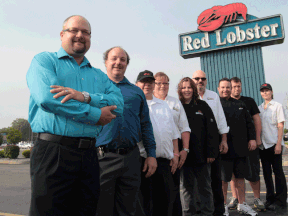 Mike Talpas, left,  general manager of the Red Lobster restaurant along with staff,  Jeff Tazzman, Jeff Wheeler, Carrie MacMillan, Debbie Henwood,  Steve Turner, Mark Phillips, Mike Boulay, and Jodi Bisutti in Windsor, Ontario on September 19, 2013. The east Windsor restaurant has won one out of twelve Canada-wide awards for excellence and participation in a food donation program. (JASON KRYK/The Windsor Star)