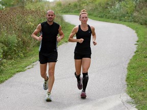 Runners Gino DiCarlo and Karin McMillan train near their home in Tecumseh recently. The couple just completed a 48-hour race. (TYLER BROWNBRIDGE / The Windsor Star)