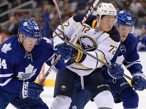 Buffalo's Luke Adam, centre, the son of former Spitfire Russ Adam, is chased by Toronto's Morgan Reilly, left, and Korbinian Holzer during NHL exhibition action in Toronto, Sunday Sept. 22, 2013. The Leafs won 5-3. (THE CANADIAN PRESS/Frank Gunn)