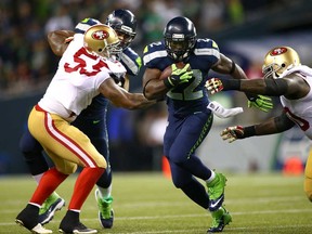 Robert Turbin, centre, of the Seattle Seahawks runs the ball against the San Francisco 49ers on September 15, 2013 at Century Link Field in Seattle. The Seahawks won 29-3. (Jonathan Ferrey/Getty Images)