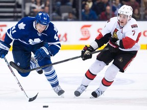 Leafs forward Nikolai Kulemin, left, battles for the loose puck against Senators forward Kyle Turris during NHL pre-season action in Toronto on Tuesday, Sept. 24, 2013. (THE CANADIAN PRESS/Nathan Denette)