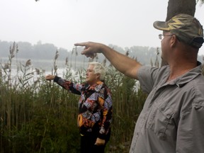 Denise Rimbert, left, and her son John Farina point to where the floating duck blind was positioned after Rimbert was hit by a stray shotgun pellet in her LaSalle backyard on Saturday, Sept. 28, 2013. (JOEL BOYCE/The Windsor Star)