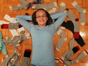 Sarah Lewis is photographed with some of the socks she has collected at her home in WIndsor on Monday, September 16, 2013. Lewis, who donates the socks to a group that works with the homeless, will be honoured for her service this Friday in Toronto.           (TYLER BROWNBRIDGE/The Windsor Star)