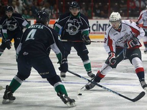 Windsor's Nikita Yazkov, right, battles Plymouth's Nick Malysa, during exhibition play at the WFCU Centre, Monday, Sept. 2, 2013. The Spitfires won 5-3. (DAX MELMER/The Windsor Star)