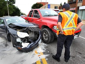 A Windsor firefighter checks out the scene of a two-car accident Monday, Sept. 9, 2013, on Tecumseh Rd. E. near Windsor Ave. in Windsor, Ont. The accident occurred at approximately 10:30 a.m. and no serious injuries were reported.