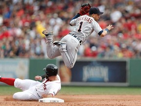Detroit shortstop Jose Iglesias, right, turns a double play over the slide of Boston's Mike Napoli at Fenway Park in Boston Monday, Sept. 2, 2013. (AP Photo/Winslow Townson)
