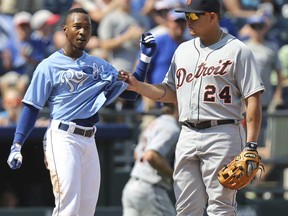 Miguel Cabrera, left, of the Detroit Tigers pulls out the shirt of Jarrod Dyson of the Kansas City Royals after Dyson hit a triple in the seventh inning at Kauffman Stadium on April September 8, 2013 in Kansas City. (Ed Zurga/Getty Images)