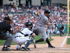Chicago's Jeff Keppinger, right, doubles to deep right field against the Detroit Tigers at Comerica Park on September 22, 2013 in Detroit. (Leon Halip/Getty Images)