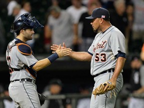 Tigers catcher Alex Avila, left, and relief pitcher Joaquin Benoit celebrate their 1-0 win over the Chicago White Sox at U.S. Cellular Field  on September 11, 2013 in Chicago. (Brian Kersey/Getty Images)