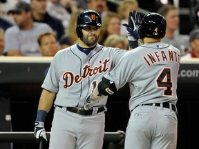 Detroit's Alex Avila, left, congratulates teammate Omar Infante on a solo home run against the Minnesota Twins during the fourth inning September 24, 2013 at Target Field in Minneapolis. (Hannah Foslien/Getty Images)