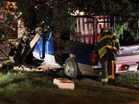 A truck rests on the front lawn on a home in Windsor on Tuesday, September 24, 2013. The owner of the truck was apprehended a short distance away by the K9 unit. Police are investigating the cause of the accident.               (TYLER BROWNBRIDGE/The Windsor Star)
