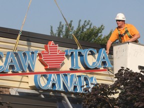 The CAW sign on the local 444 building in Windsor, Ont. came down for good Tuesday, Sept. 10, being replaced with the newly formed Unifor sign. A technician with John Labonte Sign Services removes the old sign that has been on the Turner Rd. building for 28 years. (DAN JANISSE/The Windsor Star)