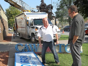 In this file photo, the CAW sign on the Local 444 building came down for good Tuesday, Sept. 10, being replaced with the newly formed Unifor sign. Gord Gray, (L) communications director and Dave Cassidy, financial secretary for Unifor 444  check out the new and old signs. (DAN JANISSE/The Windsor Star)