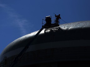 A painting crew works on the water tower in Windsor on a sunny summer day on Thursday , September 5, 2013.           (TYLER BROWNBRIDGE/The Windsor Star)