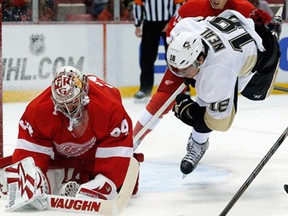 Red Wings goalie Petr Mrazek, left, makes a save in front of Pittsburgh's  James Neal during pre-season hockey action in Detroit, Wednesday, Sept. 25, 2013. (AP Photo/Paul Sancya)
