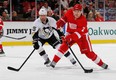 Detroit's Brendan Smith, right, takes a shot in front of Pittsburgh's Tanner Glass during a pre season game at Joe Louis Arena on September 25, 2013 in Detroit, Michigan. (Photo by Gregory Shamus/Getty Images