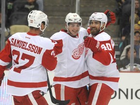 Detroit's Adam Almquist, centre, is congratulated by teammates Mikael Samuelsson, left, and Henrik Zetterberg after his goal against Pittsburgh in a pre-season game on September 16, 2013 at the CONSOL Energy Center in Pittsburgh. (Vincent Pugliese/ Getty Images)