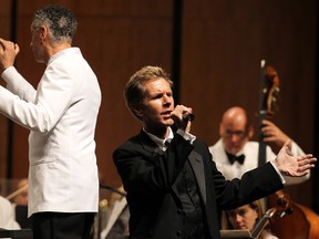 Conductor Robert Franz and vocalist David Rogers (right) perform during the opening night of the WSO in the Capitol Theatre in Windsor on Friday, September 27, 2013.                (TYLER BROWNBRIDGE/The Windsor Star)