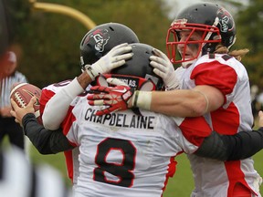 Vancouver Island's Dylan Chapdelaine, centre, celebrates with teammates after scoring on an interception in the second quarter of the Canadian Junior Football League semifinal between the AKO Fratmen and the visiting Vancouver Island Raiders at Windsor Stadium, Saturday, Oct. 26, 2013.  Vancouver Island defeated AKO 50-3.  (DAX MELMER/The Windsor Star)