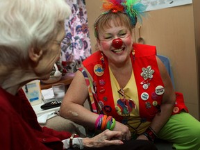 Sandra Radvanyi, also known as Merry Kay!, visits with Frances Colvin, 89, left, at Extendicare Tecumseh, Saturday, Oct. 26, 2013.  Radvanyi is a familial clown who uses humour and art when she visits with seniors.  (DAX MELMER/The Windsor Star)