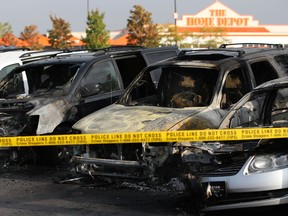 A row of five vehicles lay charred at Windsor Pre-owned Auto Sales on the 6500 block of Tecumseh Rd. East, after an early morning fire, Saturday, Oct. 5, 2013.  (DAX MELMER/The Windsor Star)