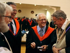 Michael Closs, left, Phil Alexander, Walter Culina, Adrian van den Hoven and John J. Hubert, all members of the University of Windsor class of 1963, socialize before being honoured at the university's 100th convocation at the St. Denis Centre, Saturday, Oct. 19, 2013.  The class of 1963 was being honoured as part of the University of Windsor's 50th anniversary celebration.  (DAX MELMER/The Windsor Star)