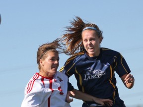 Windsor's Corinne Robinson battles Brock's Jess Bagnulo, left, for the ball in OUA woman's soccer action at Alumni Field, Sunday, Oct. 13, 2013.  (DAX MELMER/The Windsor Star)