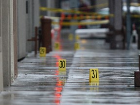 Evidence markers line the east side sidewalk of Pelissier St. between Park St. and University Ave. after an early morning fatal stabbing, Saturday, Oct. 19, 2013.  (DAX MELMER/The Windsor Star)