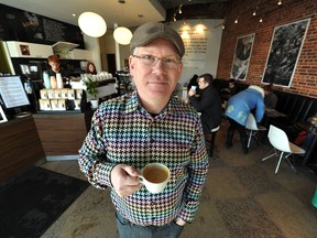 John Lucas/Edmonton Journal
Transcend Coffee founder Poul Mark hoists a cup in his Garneau Coffee Shop in Edmonton.
