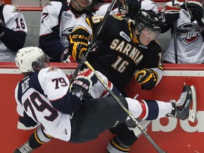 Windsor's Ty Bilcke, left, collides with Sarnia's Davis Brown at the WFCU Centre. (TYLER BROWNBRIDGE/The Windsor Star)