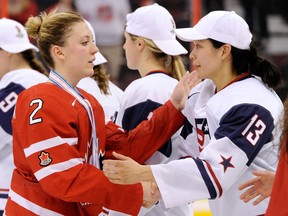 Ruthven's Meghan Agosta-Marciano, left, congratulates Julie Chu of Team USA during the IIHF Womens World Championship gold medal game at Scotiabank Place in Ottawa. Team USA defeated Team Canada 3-2. (Photo by Richard Wolowicz/Freestyle Photography/Getty Images)