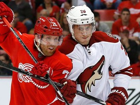 Detroit's Daniel Cleary, left, is checked by Phoenix's Michael Stone Thursday. (AP Photo/Paul Sancya)