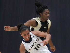 Windsor's Miah-Marie Langlois, front, gets tangled up with Concordia's Tina Mpondani Friday at the St. Denis Centre. (DAN JANISSE/The Windsor Star)