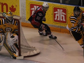 Sarnia's Anthony DeAngelo, right, is chased by Windsor's Kerby Rychel in front of Sarnia goalie Brodie Barrick Friday in Sarnia. (Courtesy of the Sarnia Observer)