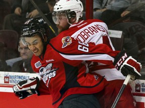 Windsor's Josh Ho-Sang, left, checks the Soo's Alex Gudbranson at the WFCU Centre last year. (NICK BRANCACCIO/The Windsor Star)