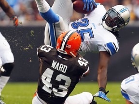 Detroit's Joique Bell, top, is tackled by Cleveland's T.J. Ward at FirstEnergy Stadium in Cleveland Sunday. (Photo by Matt Sullivan/Getty Images)